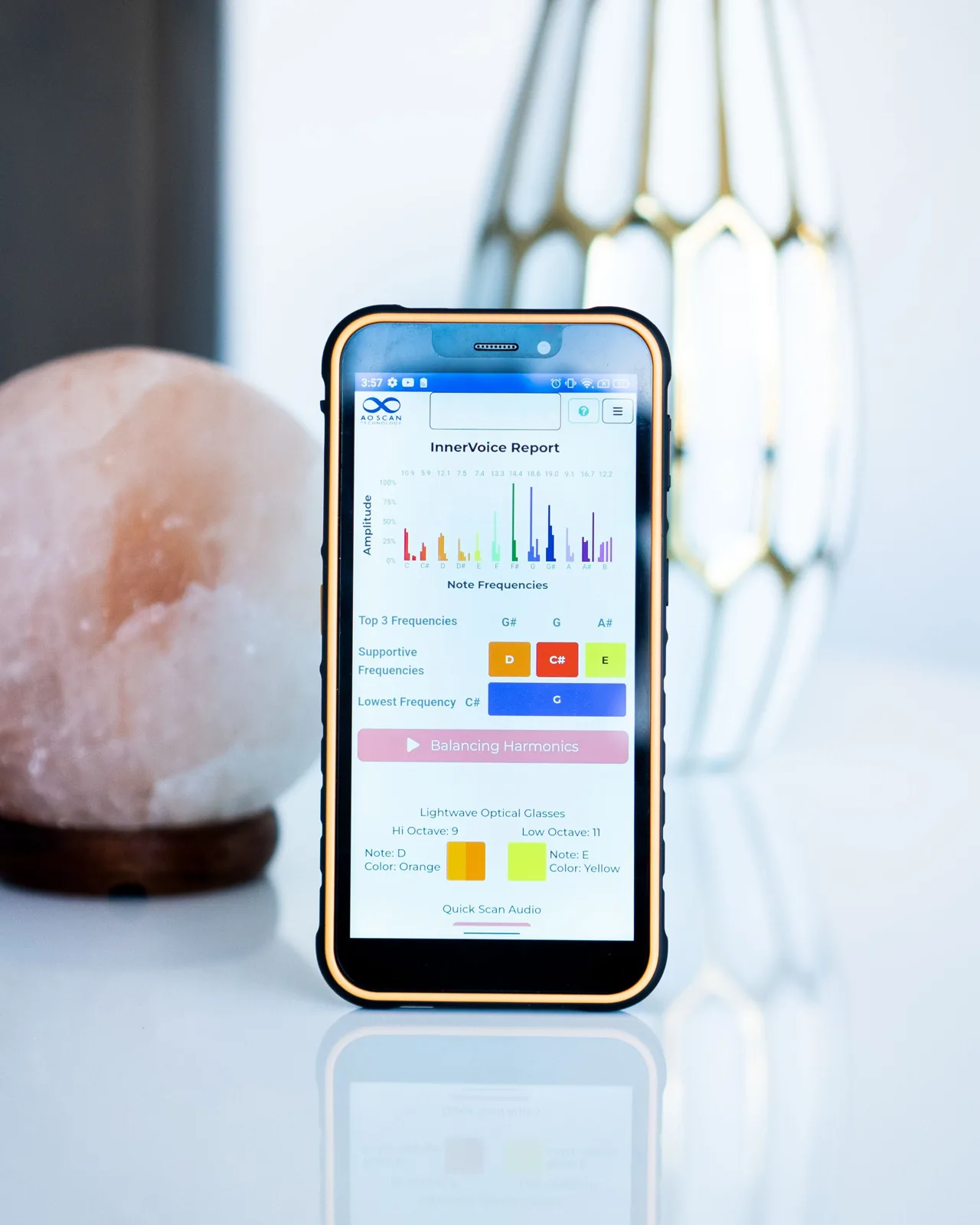 The Inner Voice frequency report on a phone beside a Himalayan salt lamp